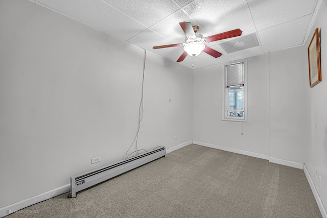 carpeted empty room featuring ceiling fan and baseboard heating