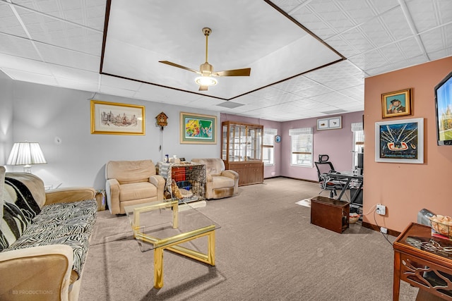 carpeted living room with ceiling fan