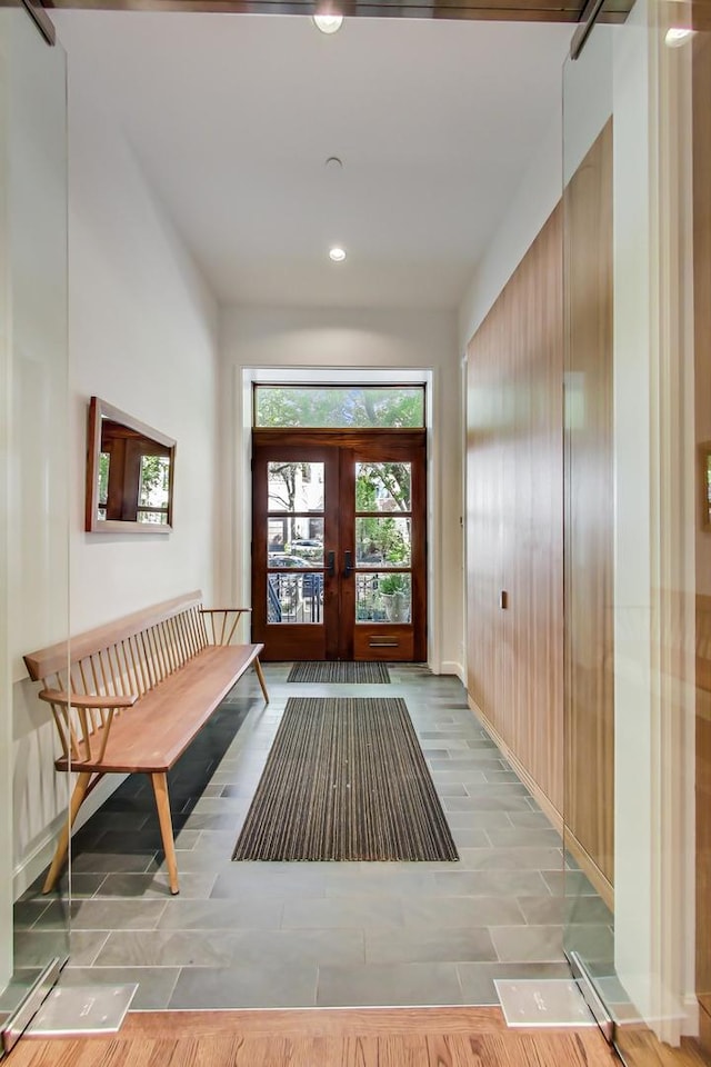 foyer entrance featuring french doors and light hardwood / wood-style flooring