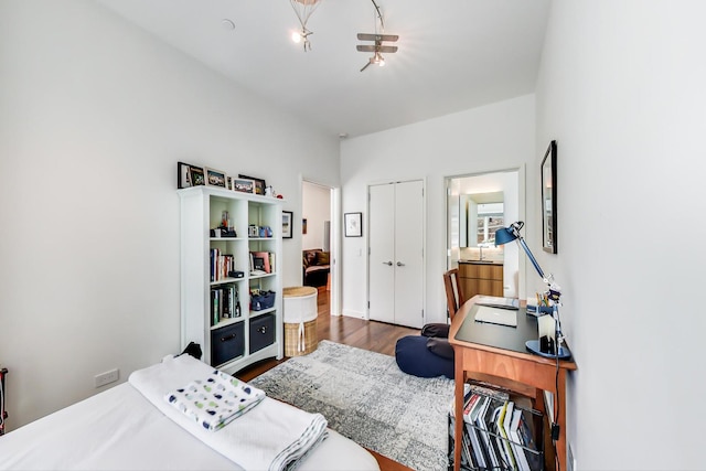 bedroom with hardwood / wood-style floors and a closet