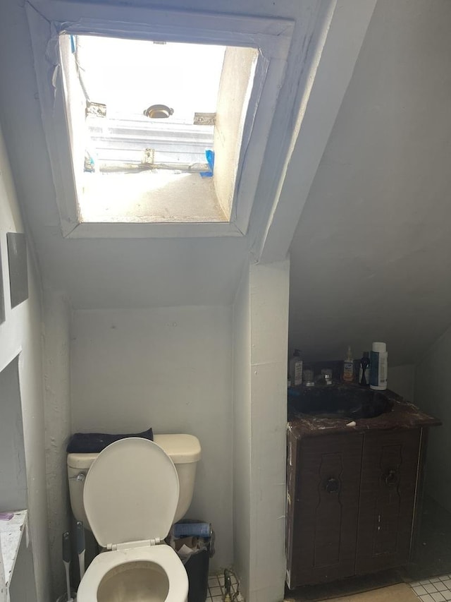 bathroom featuring tile patterned floors, vanity, and toilet