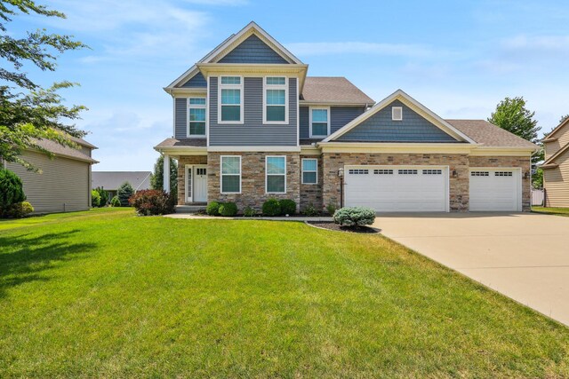 craftsman inspired home with a garage and a front yard