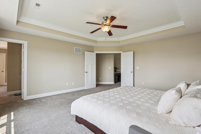 bedroom featuring a tray ceiling, baseboards, and visible vents