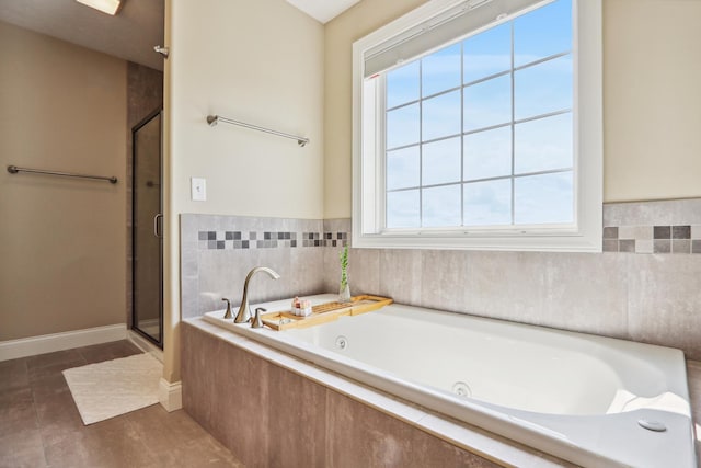 full bath featuring tile patterned floors, baseboards, a whirlpool tub, and a shower stall