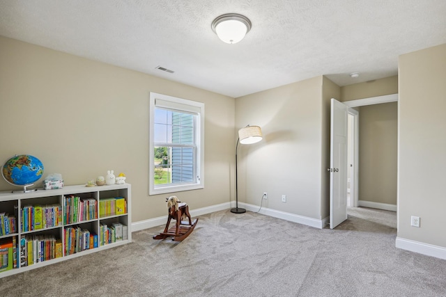 recreation room with visible vents, a textured ceiling, baseboards, and carpet floors