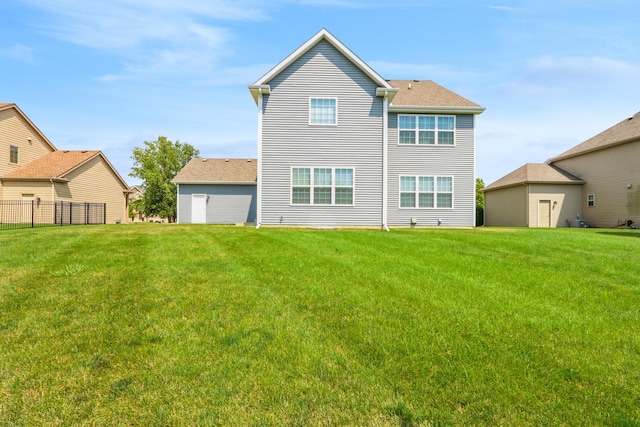 back of house featuring a yard