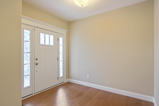 entryway featuring baseboards and wood-type flooring