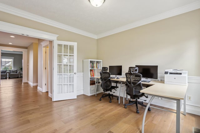 office space featuring hardwood / wood-style floors, crown molding, and baseboards