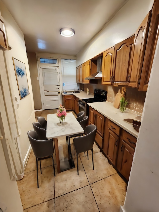 kitchen featuring decorative backsplash, electric range, light tile patterned floors, and wall chimney range hood