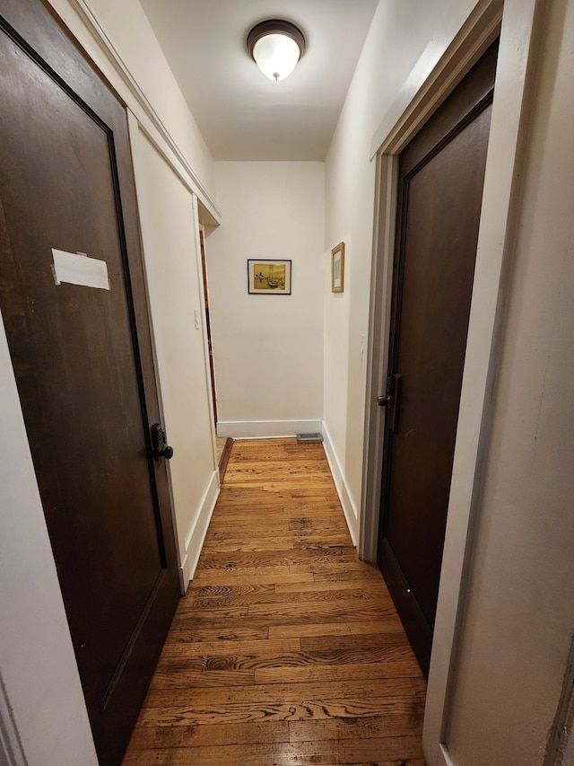 hall with hardwood / wood-style floors