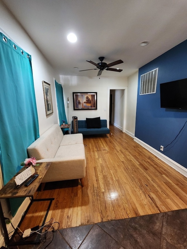 living room with ceiling fan and light hardwood / wood-style floors