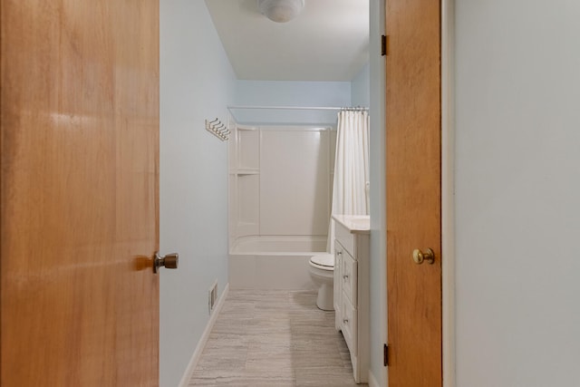 full bathroom featuring vanity, shower / bath combo, and toilet