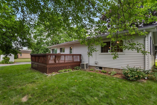 back of house with a deck, a lawn, and central air condition unit