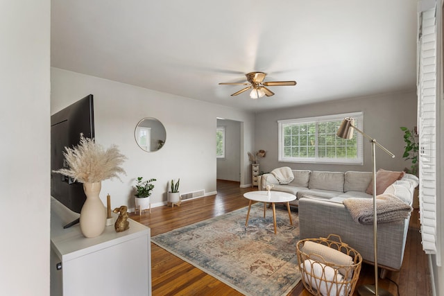 living room with dark hardwood / wood-style floors and ceiling fan