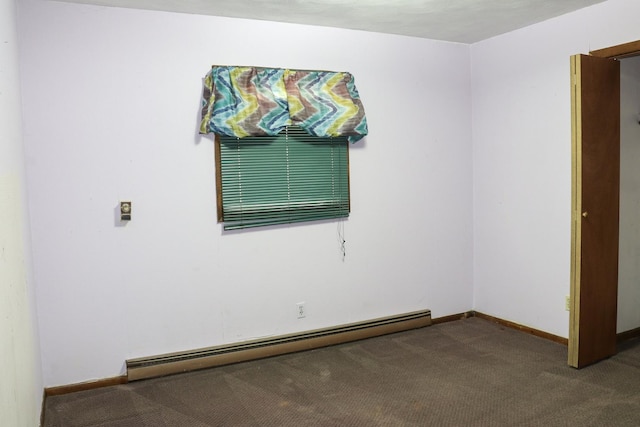 carpeted empty room featuring baseboard heating