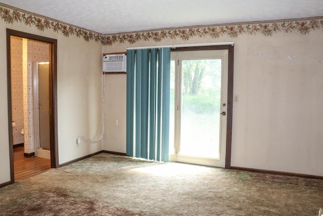 carpeted empty room featuring a wall mounted air conditioner