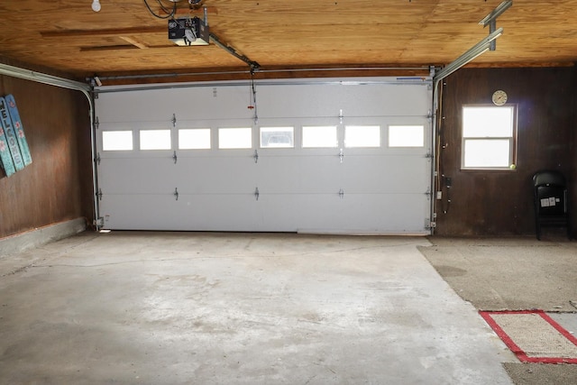 garage featuring wood ceiling and a garage door opener