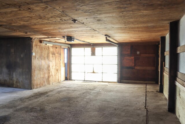 garage featuring wooden ceiling and a garage door opener