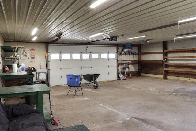 garage with a workshop area and a garage door opener