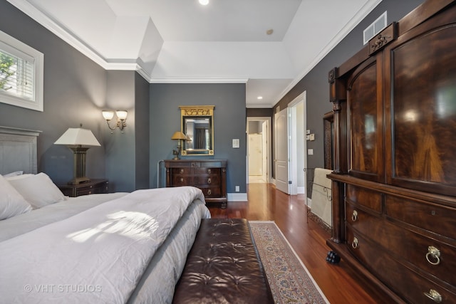 bedroom with ornamental molding and dark hardwood / wood-style flooring