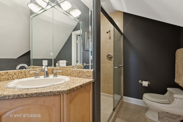 bathroom featuring vanity, lofted ceiling, a shower with door, toilet, and tile patterned floors