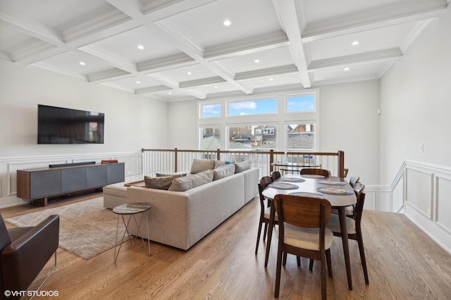 living room with beamed ceiling, ornamental molding, light hardwood / wood-style flooring, and coffered ceiling