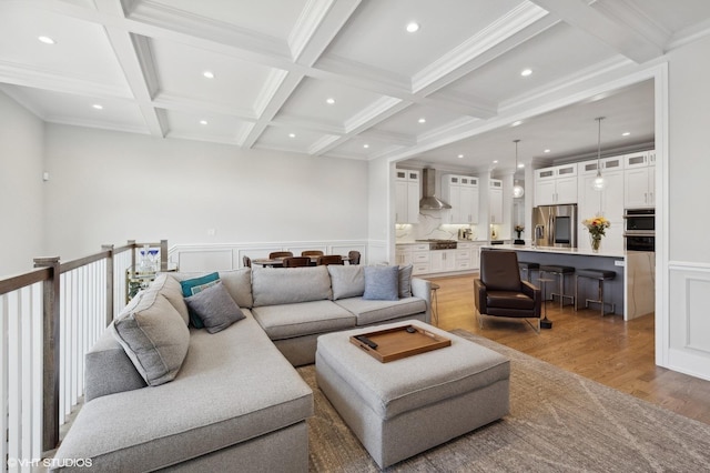 living room featuring beamed ceiling, crown molding, hardwood / wood-style flooring, and coffered ceiling