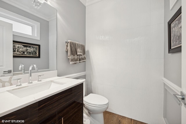 bathroom featuring hardwood / wood-style floors, vanity, toilet, and ornamental molding