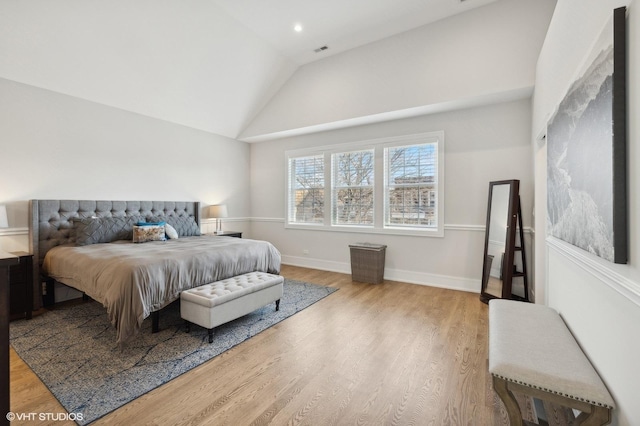 bedroom with hardwood / wood-style flooring and lofted ceiling