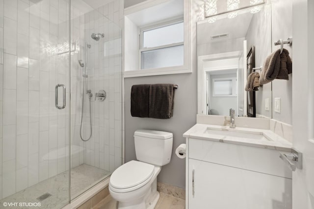 bathroom featuring vanity, toilet, and walk in shower