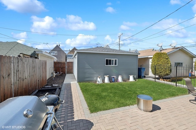 rear view of property featuring a patio area and a yard