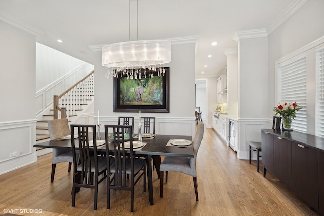 dining area featuring crown molding and light hardwood / wood-style floors