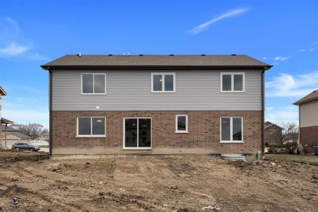 rear view of property with brick siding