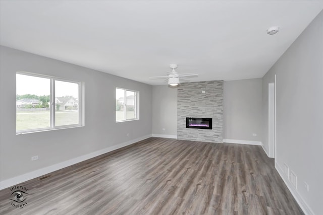 unfurnished living room featuring a fireplace, wood-type flooring, and ceiling fan