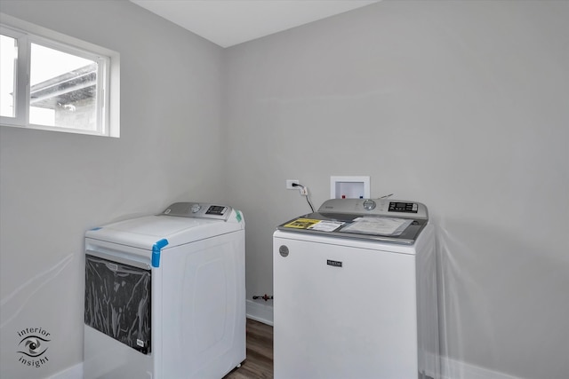 clothes washing area with separate washer and dryer, hardwood / wood-style flooring, and hookup for a washing machine