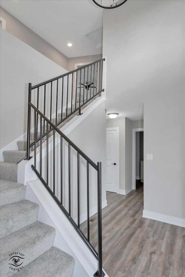 stairway featuring hardwood / wood-style flooring