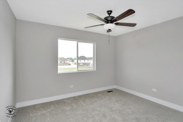 carpeted empty room featuring ceiling fan