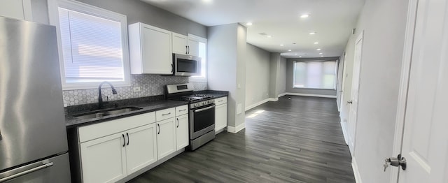 kitchen featuring a wealth of natural light, white cabinetry, and stainless steel appliances