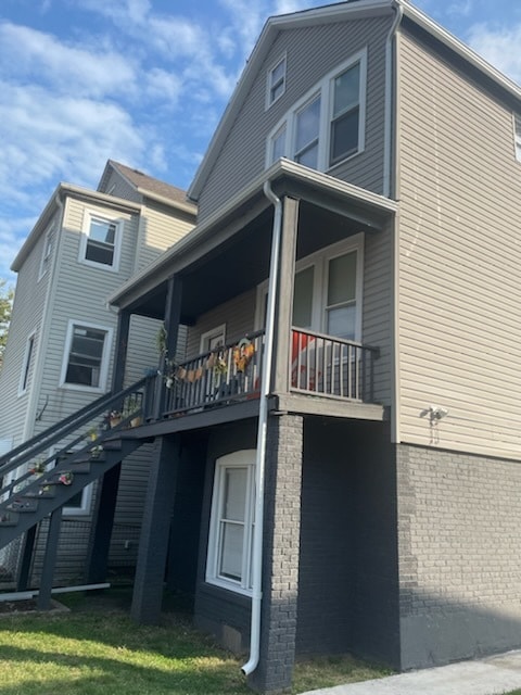 view of property exterior featuring a yard and a balcony