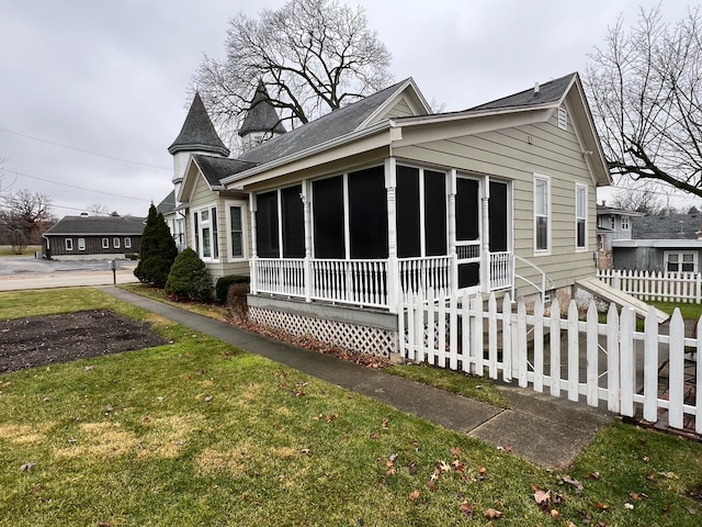 view of property exterior featuring a yard and a sunroom