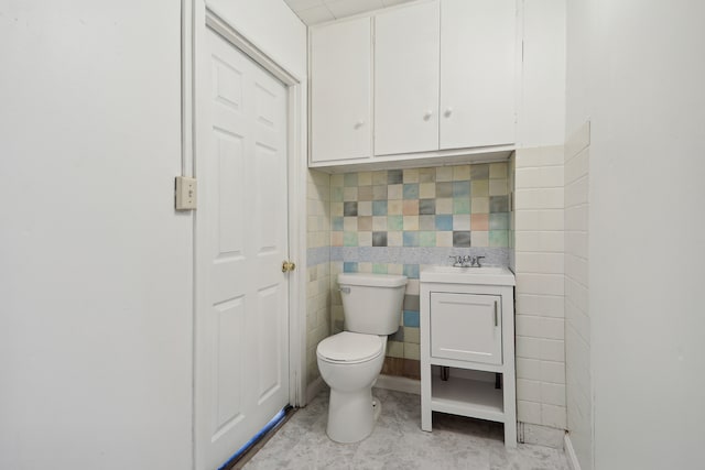 bathroom with vanity, tile patterned flooring, toilet, and tile walls