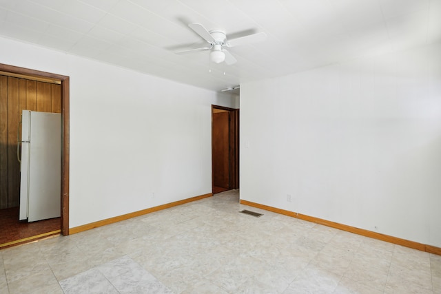 tiled spare room with ceiling fan