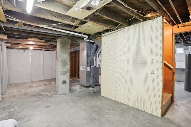 basement featuring heating unit and water heater