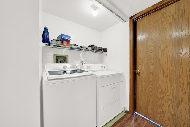 clothes washing area with dark hardwood / wood-style flooring and washer and clothes dryer