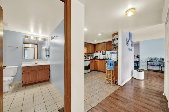 interior space featuring light tile patterned flooring, sink, and stove