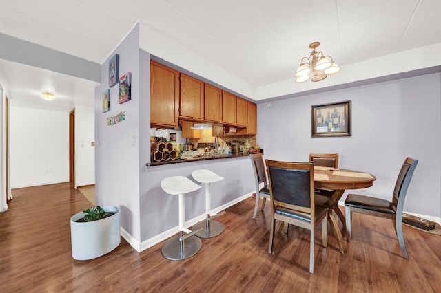 dining area with hardwood / wood-style flooring and a chandelier