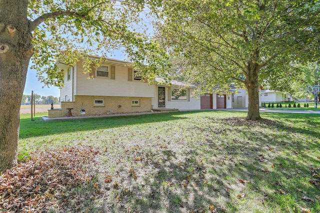 view of front of home with a garage and a front lawn