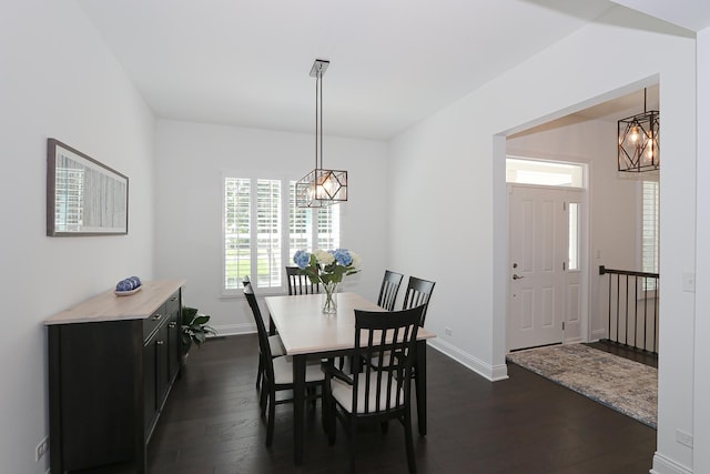 dining room featuring dark hardwood / wood-style floors and an inviting chandelier