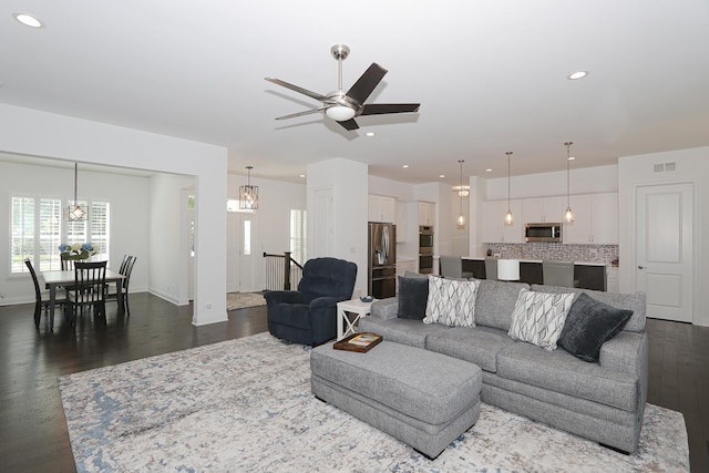 living room with ceiling fan and wood-type flooring