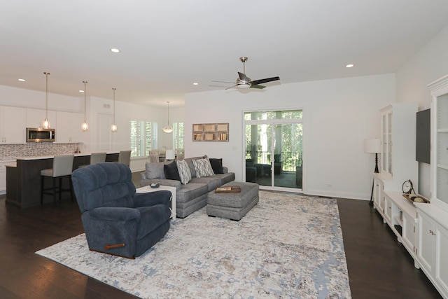 living room with dark hardwood / wood-style floors and ceiling fan